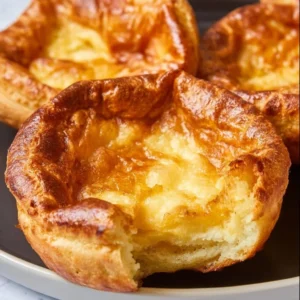 Fluffy Air Fryer Yorkshire Pudding ready to serve with gravy.