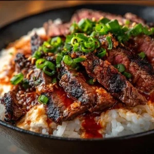 Savory Korean BBQ steak rice bowl with vibrant vegetables and spicy sauce