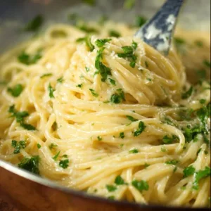 Delicious bowl of Garlic Parmesan Pasta garnished with fresh herbs