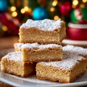Holiday Vanilla Cinnamon Snack Cake Bars topped with frosting and cinnamon sugar.