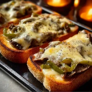 Delicious steak and cheese garlic toast served with toppings