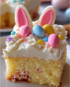 Easter Bunny Poke Cake decorated with pastel frosting and bunny accents