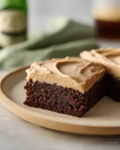 Decadent Guinness brownies with frosting on a plate