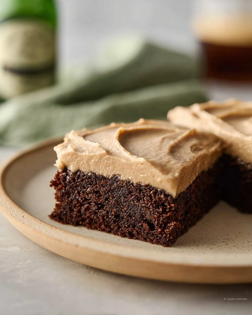 Decadent Guinness brownies with frosting on a plate