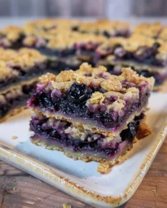Delicious blueberry crumble bars on a white plate