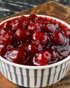 Homemade cherry pie filling with fresh cherries for baking.