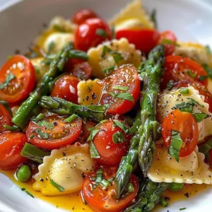 Ravioli served with tomatoes, asparagus, and fresh herbs on a plate