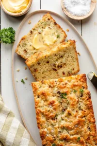 Savory cheese quick bread fresh out of the oven, golden brown and cheesy.